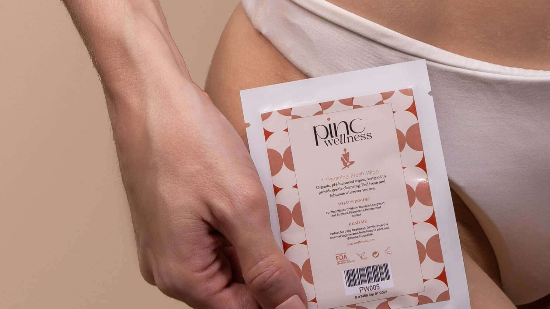 Woman holding natural intimate care products with a soft, comforting background