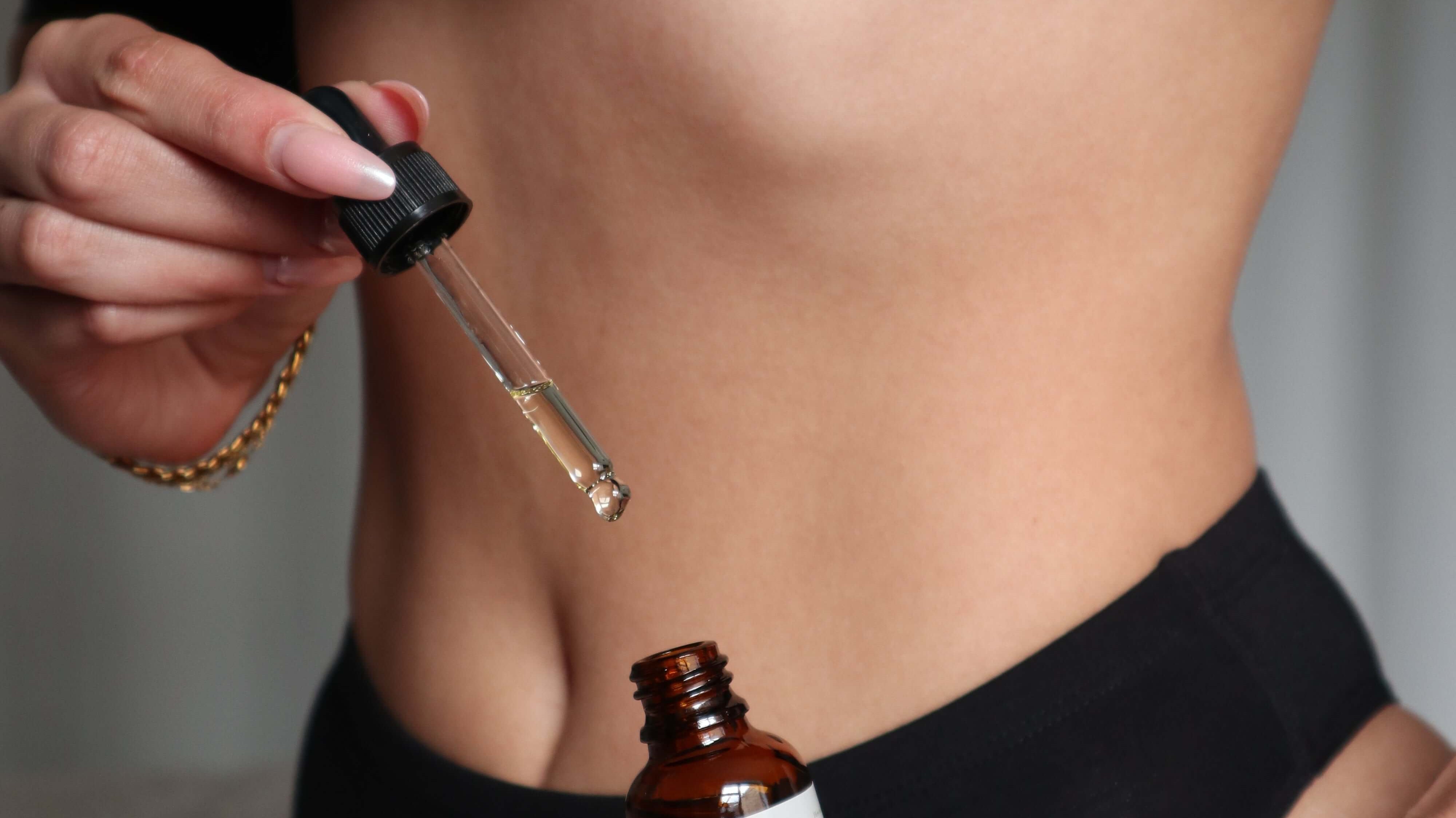 Close-up of a woman showing discomfort with a natural intimate care product nearby