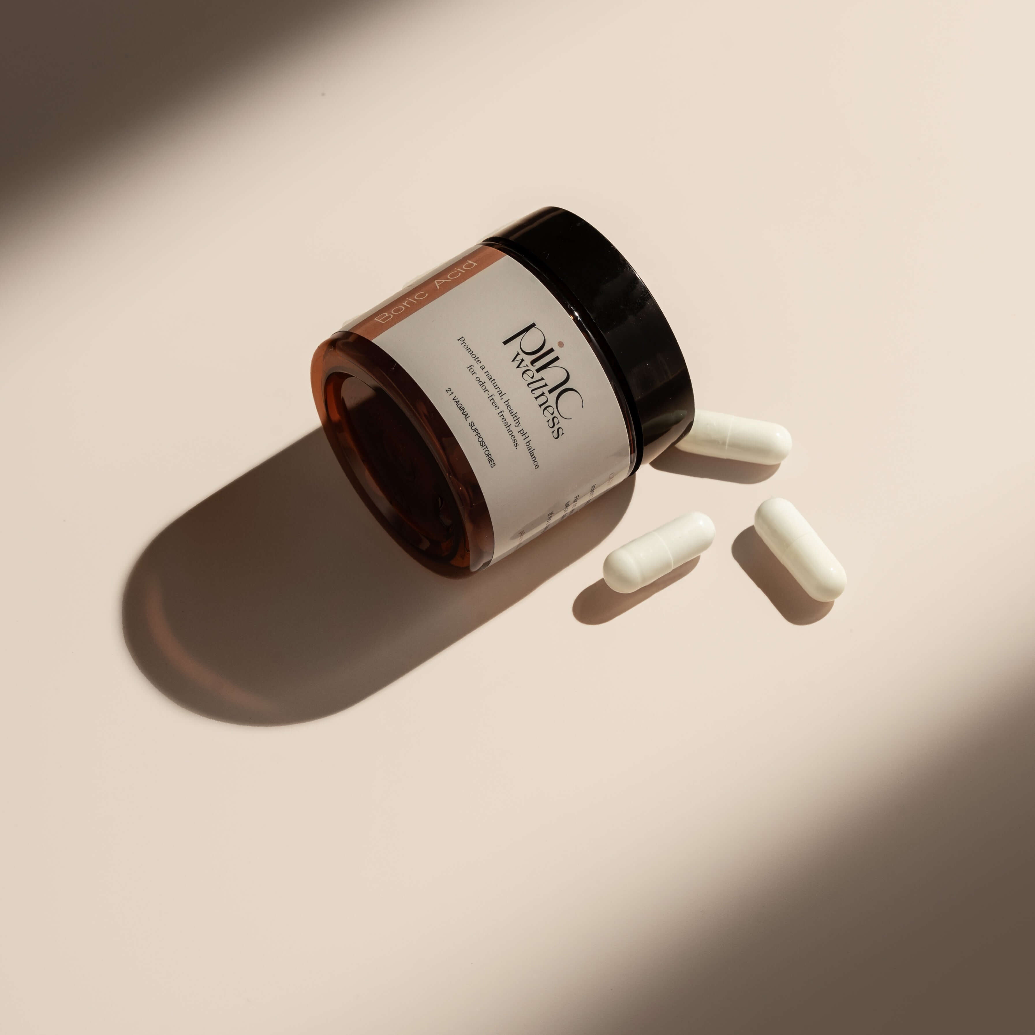 A jar of boric acid and 3 capsules by Pinc Wellness