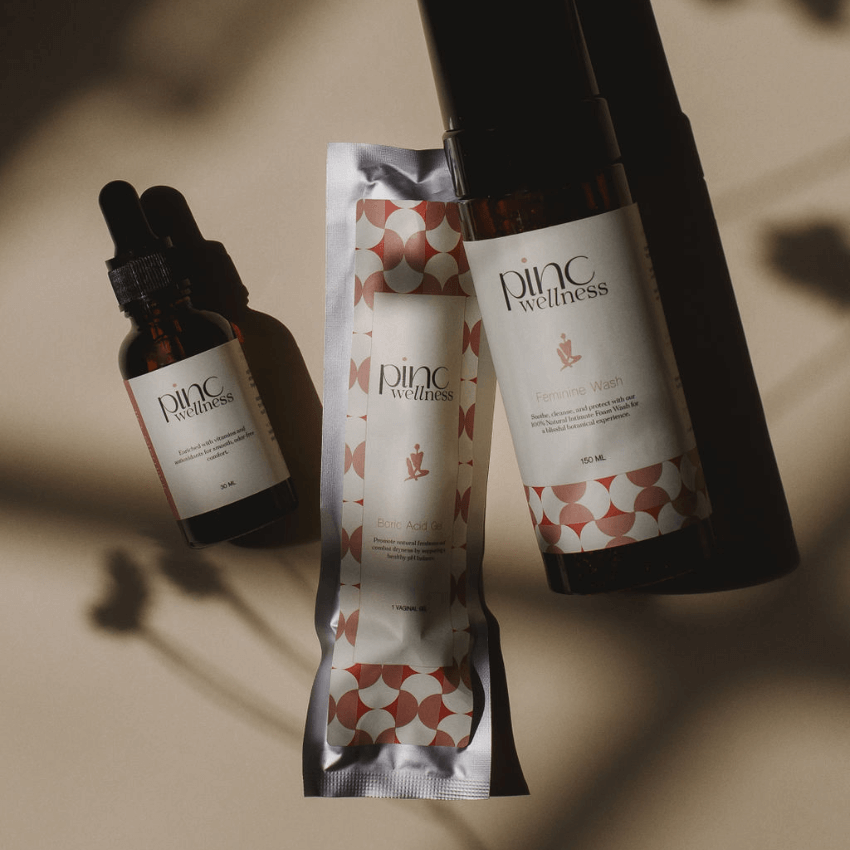 Three Pinc Wellness skincare products on beige, soft shadows, natural feel.