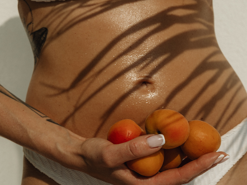 A picture of a women holding peaches