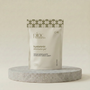 A stand-up pouch of Pinc Wellness Hyaluronic Intimate Gel, displayed on a round gray stone pedestal against a warm beige background.