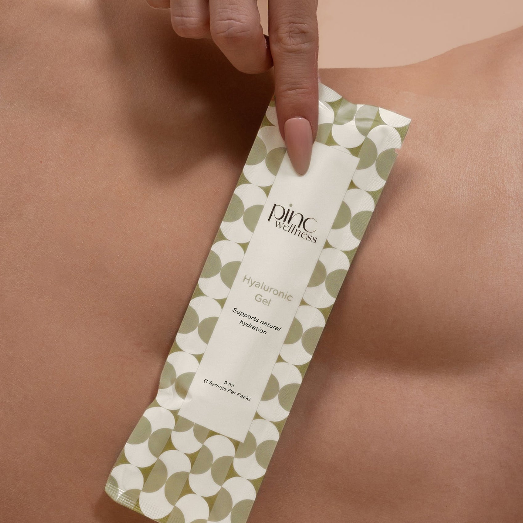 Hand applying a green and white wax strip to a person's skin, with 'Pinc' branding visible.