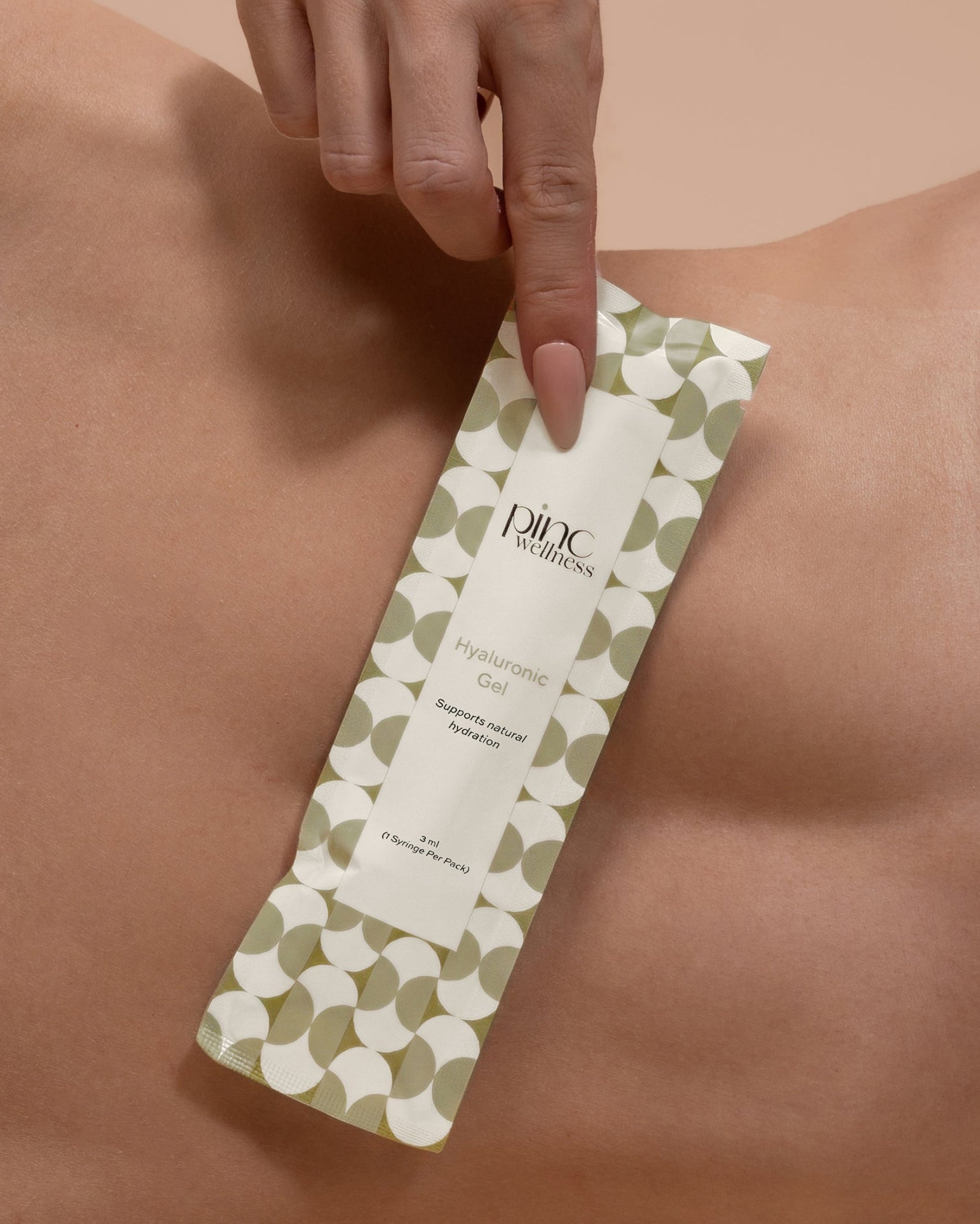 Hand applying a green and white wax strip to a person's skin, with 'Pinc' branding visible.