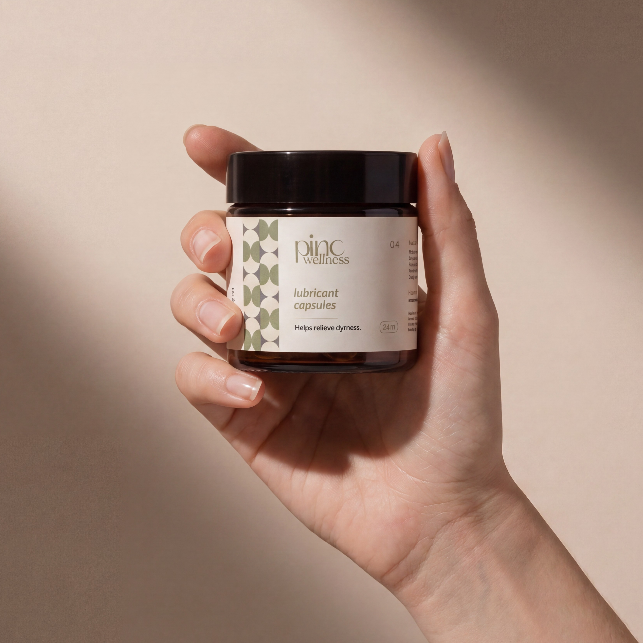 a hand holding a jar of lubricant capsules