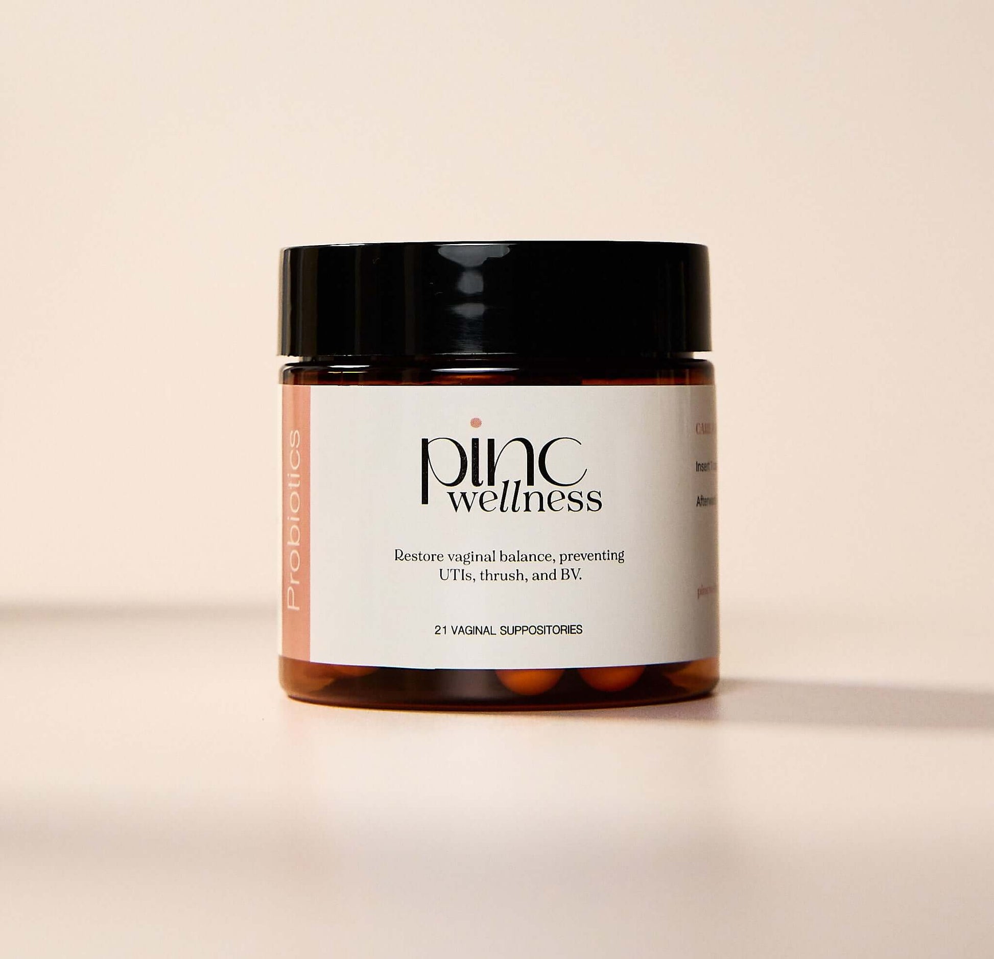 Pinc Wellness probiotics jar on pale background, vaginal health benefits.