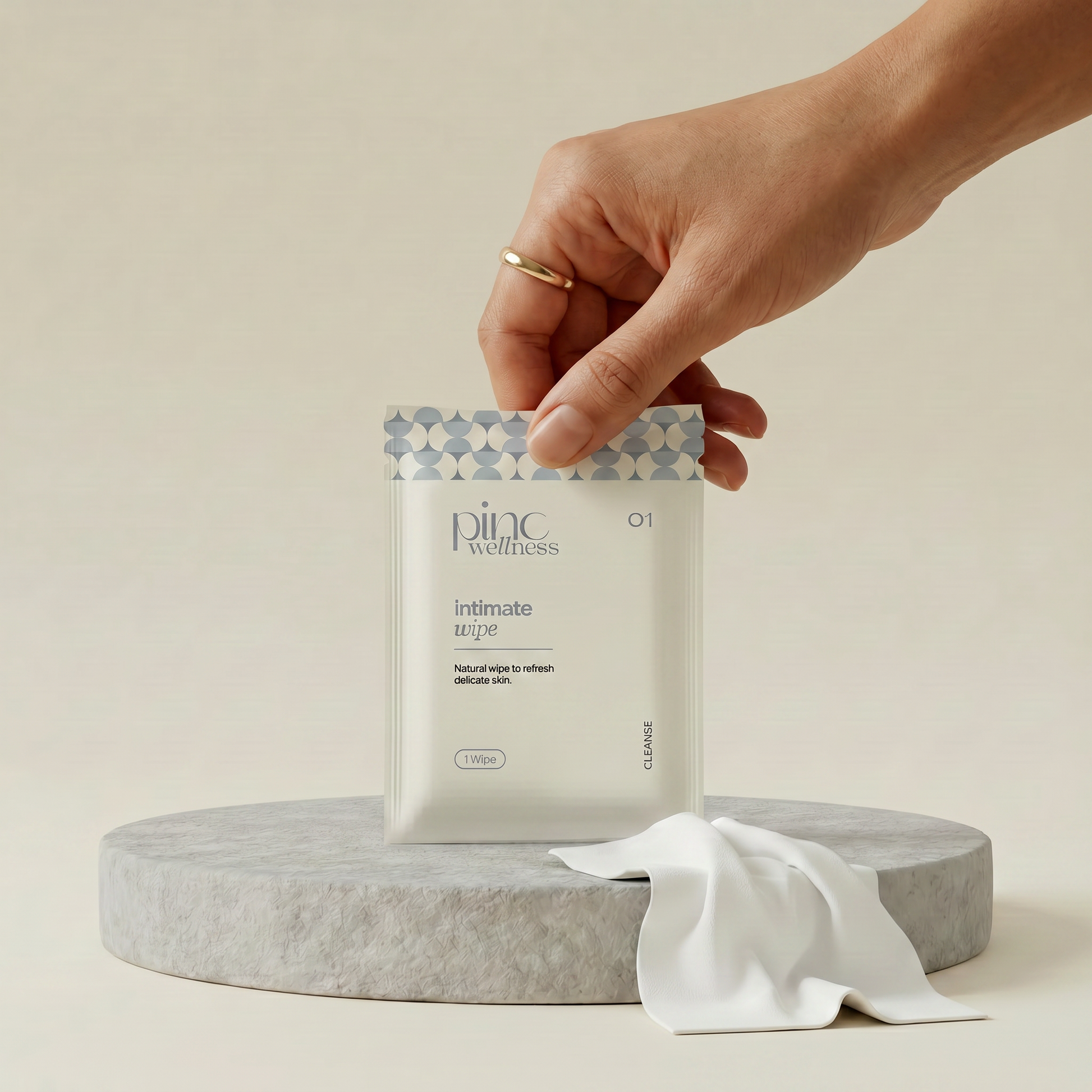 Hand holding a package labeled 'pine wellness' on a neutral background